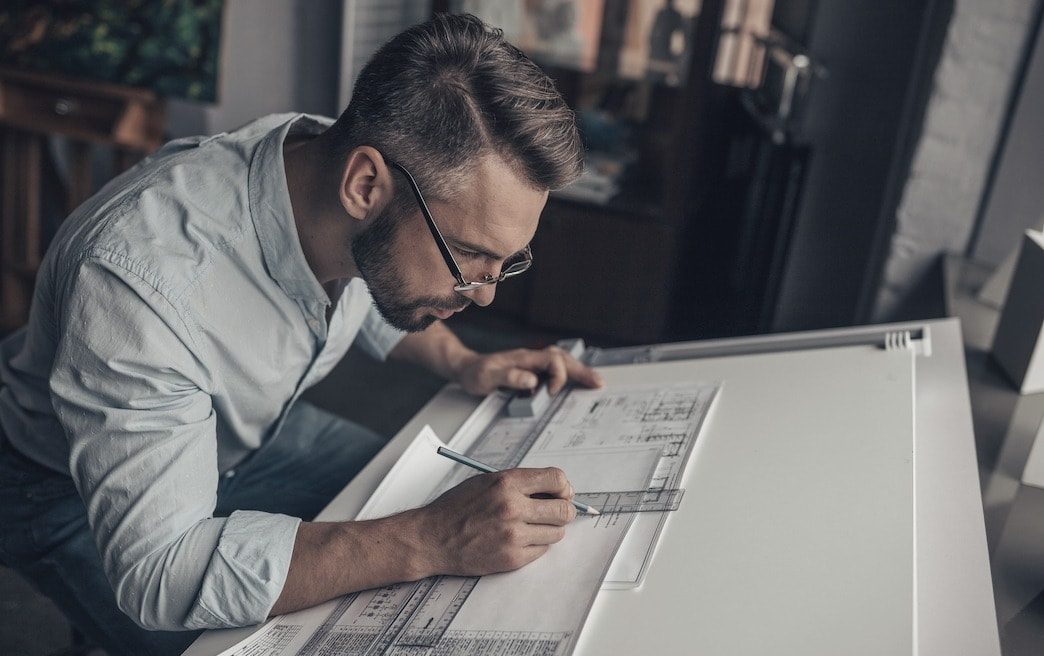 Young architect with drawing in the studio